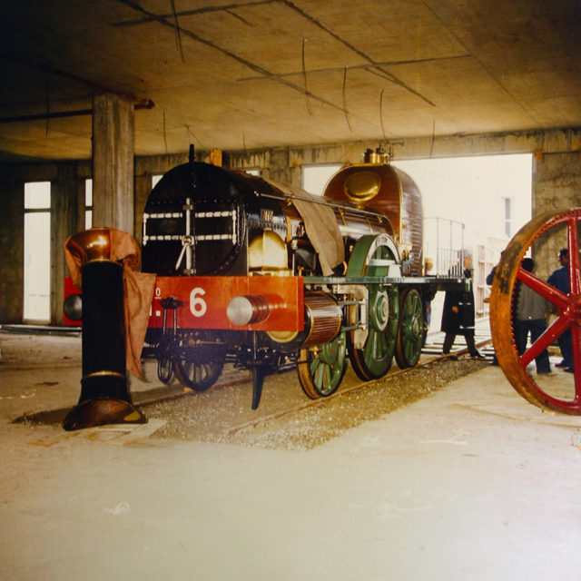 Michel Lamarche, The locomotive L’Aigle in the new museum building; caption: Reception building constructed in a way around L’Aigle, photograph, 6 June 1977, Cité du Train collection, stored in the Municipal Archives of Mulhouse